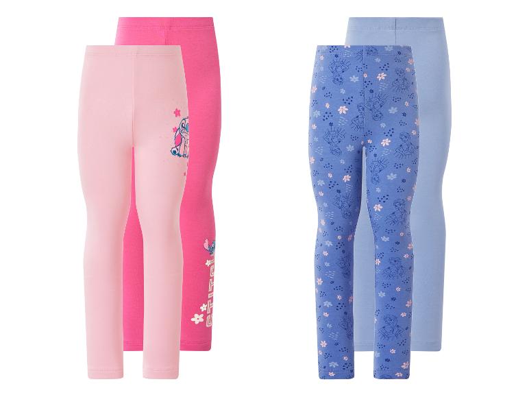 Set van vier kinderleggings: twee roze met alien-thema en twee blauwe met prinsessen-thema.
