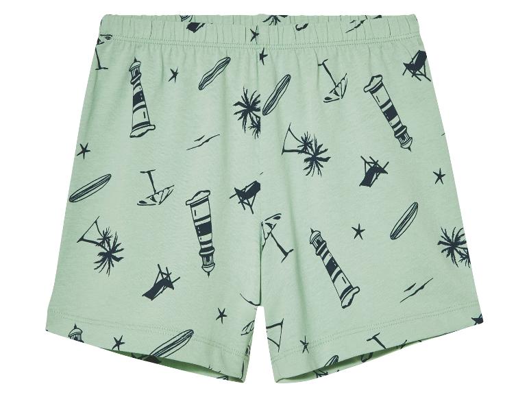Lichtgroene shorts met print van vuurtorens, palmbomen en surfplanken.