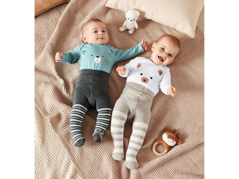 Twee baby's dragen blauwe en witte onesies met berenprint en gestreepte leggings.