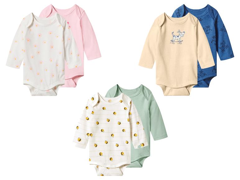 Zes rompertjes met lange mouwen in diverse kleuren en patronen, waaronder bloemen, honden en bijen.