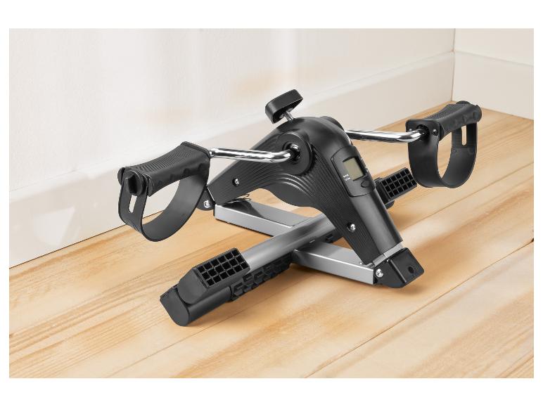 Zwart-zilveren mini hometrainer met digitaal display op een houten vloer.
