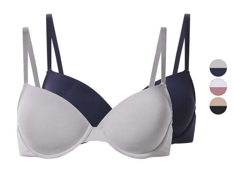 Twee beha's in wit en donkerblauw met bijpassende kleurpaletten.