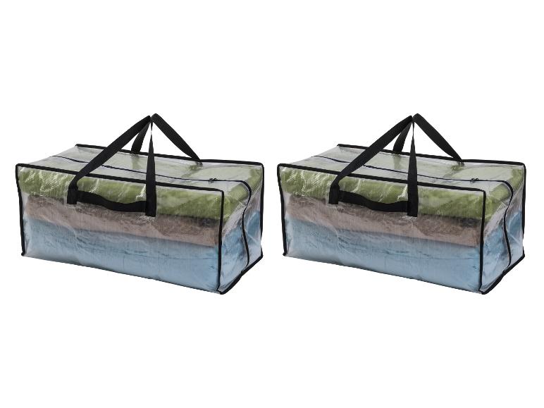 Twee doorzichtige opbergtassen met opgevouwen dekens erin.