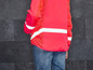Een rood jack met reflecterende strepen en een mesh-paneel.