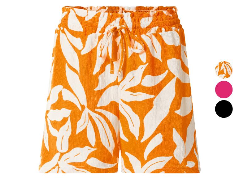 Dames shorts met oranje en witte bladprint, elastische tailleband en trekkoord.
