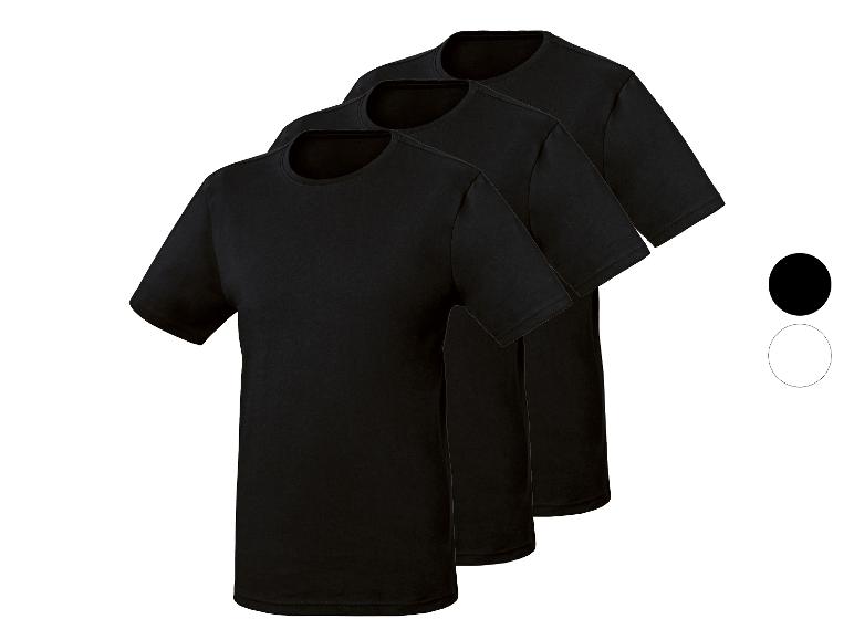 Drie zwarte T-shirts met ronde hals, diagonaal gerangschikt