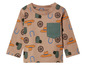 Beige baby longsleeve met cowboyhoeden, hoefijzers en wielen.
