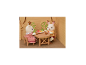 Twee konijnenbeeldjes zitten aan een houten tafel met een fruitschaal.