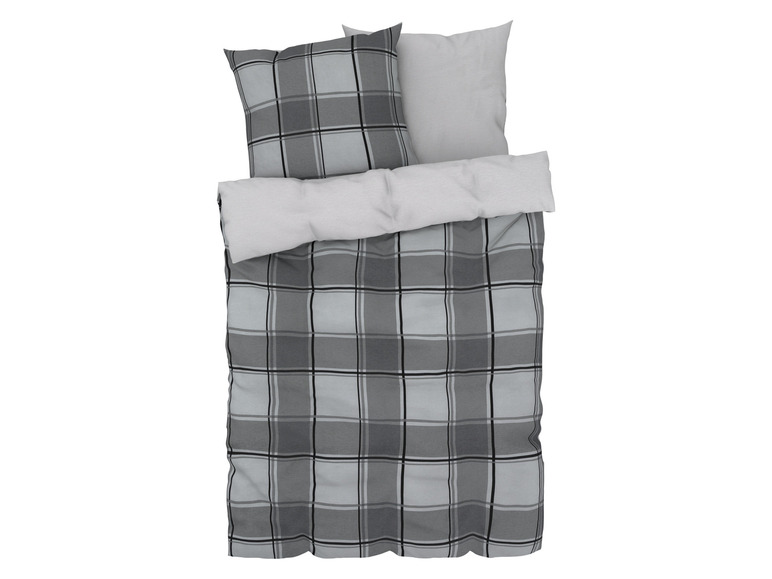 Een grijs plaid beddengoed met ruitjespatroon.