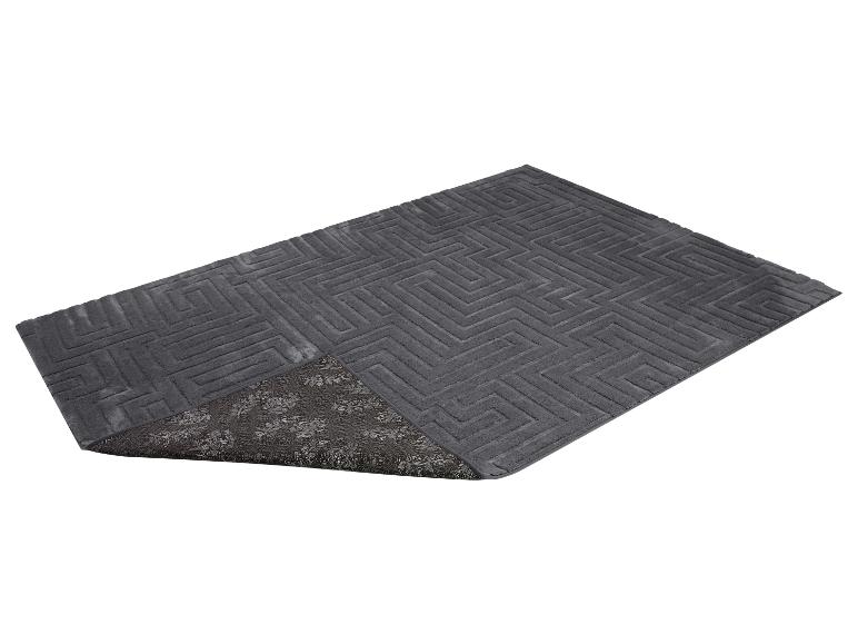 Grijze badmat met een geometrisch patroon en een antislip onderkant met bloemmotief.