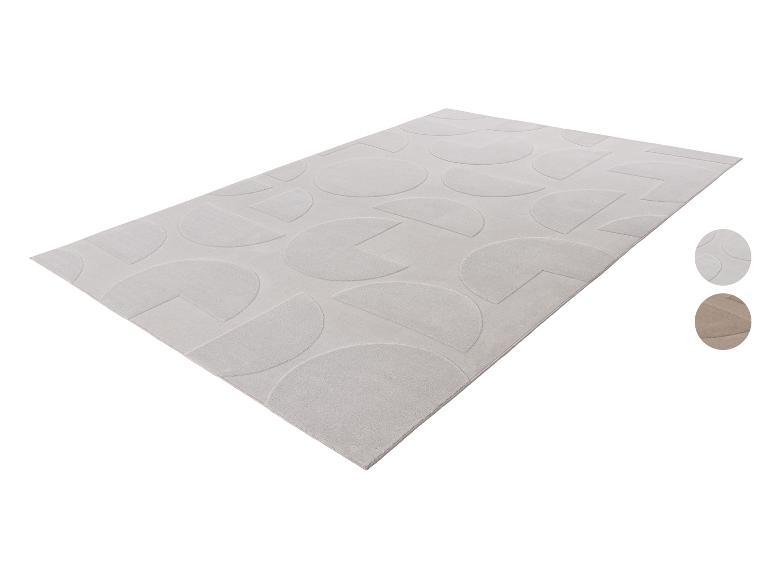 Lichtbeige rechthoekig vloerkleed met geometrisch patroon van halve en kwart cirkels.
