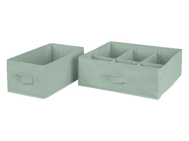 Twee groene opbergboxen, een met meerdere vakken.