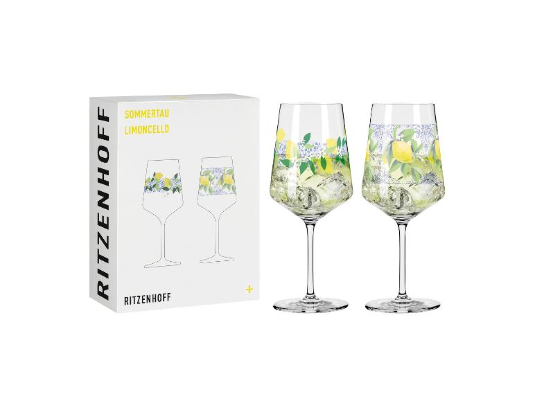 Twee limoncello glazen met citroen- en bloemenpatroon, naast een witte doos.
