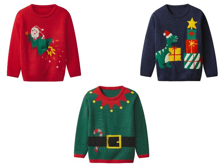 Drie kersttruien: een rode met de kerstman op een raket, een blauwe met een dinosaurus en cadeaus, een groene elftrui.