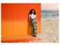 Vrouw in ESMARA® T-shirt-body en broek met print bij het strand.