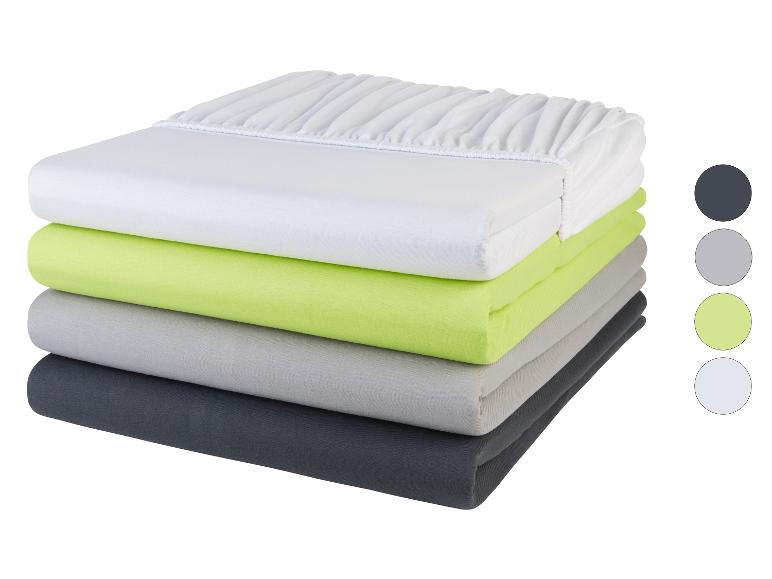 Stapel hoeslakens: wit, limoengroen, grijs en antraciet.