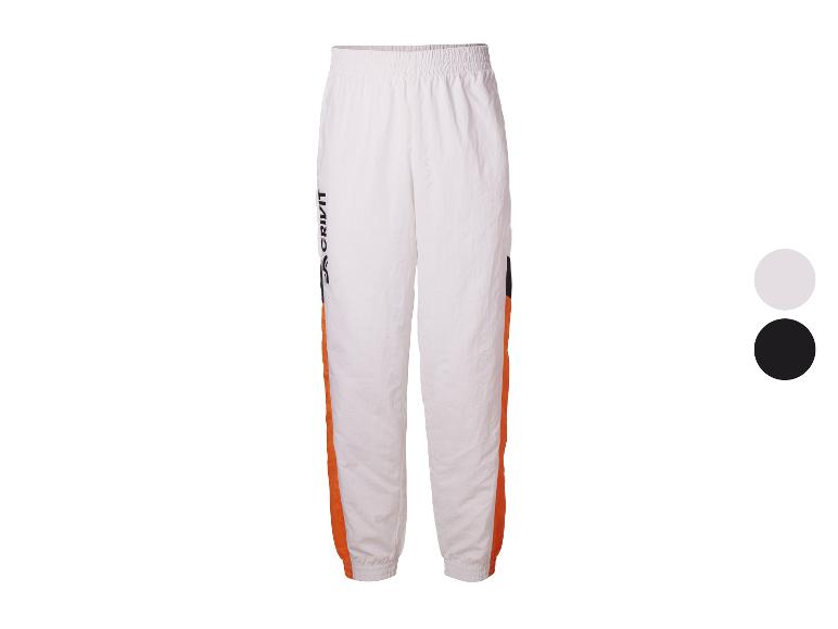 Witte trainingsbroek met oranje en zwarte strepen