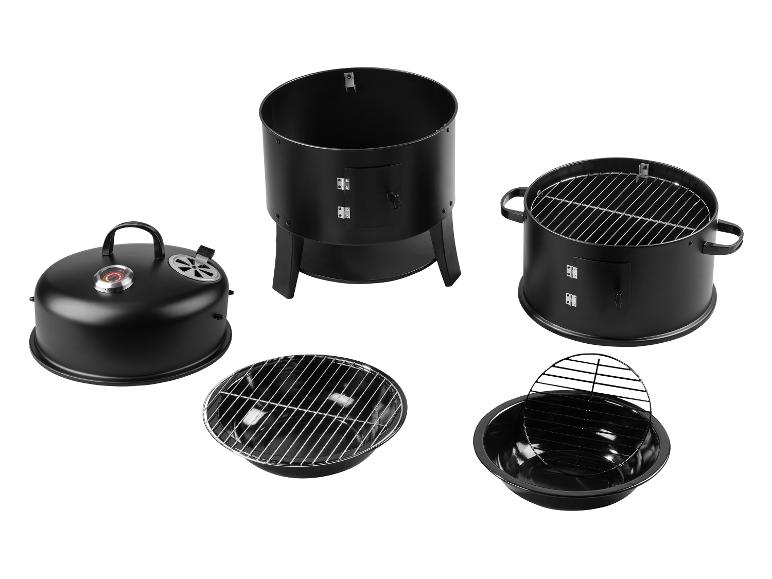 Zwarte barbecue- en rookset, gedemonteerd in onderdelen.