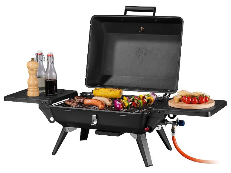 Draagbare gasbarbecue met eten, kruiden en drankjes