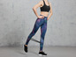 Een vrouw draagt sportkleding en gebruikt een weerstandsband tijdens een workout.