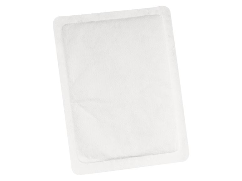 Een wit warmtekussen in een geïsoleerde verpakking.