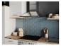 Moderne keuken met afzuigkap, kookplaat en blauwe tegels.