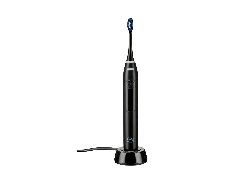 Zwarte Cien Beauty elektrische tandenborstel op een oplaadstation.