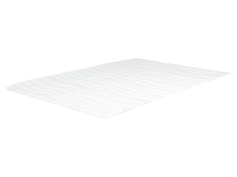 Een wit matras met een golvend patroon.