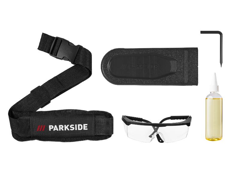 Parkside accessoirekit met draagriem, veiligheidsbril, zaagbladbeschermer, sleutel en olie.
