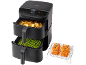 Zwarte dubbele airfryer met friet, asperges en gegrilde zalm.