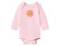 Roze babyromper met lange mouwen en lachend bloemenpatroon