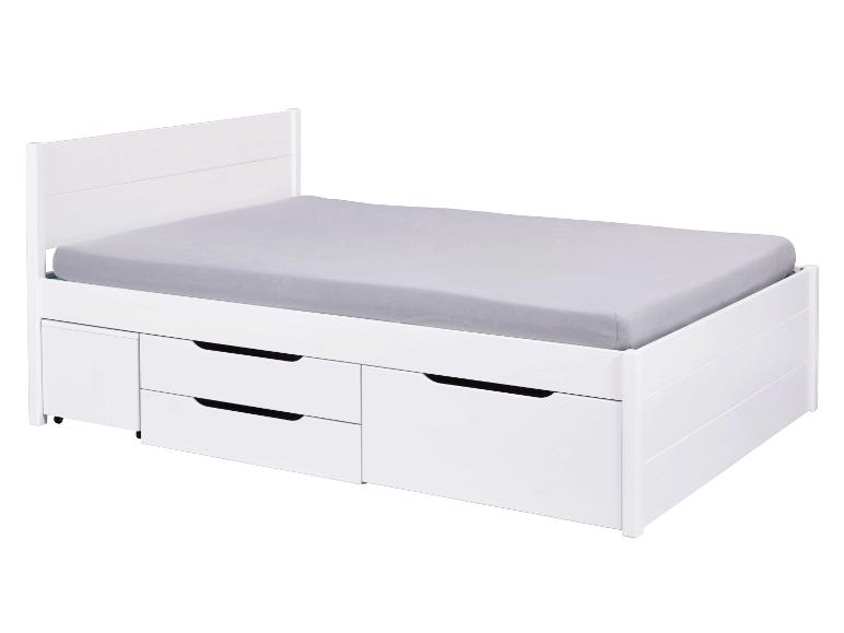 Wit bed met drie laden.