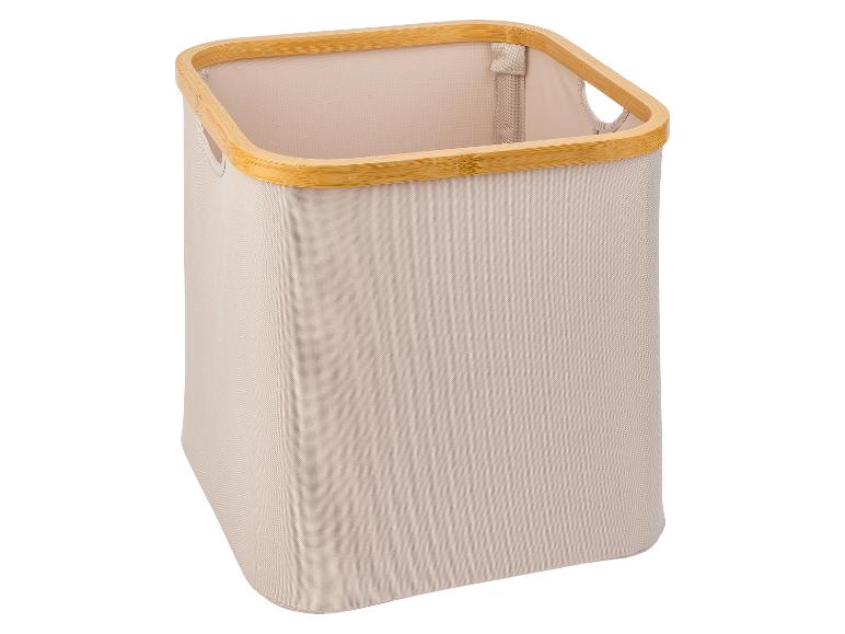 Beige wasmand van stof met bamboe rand.