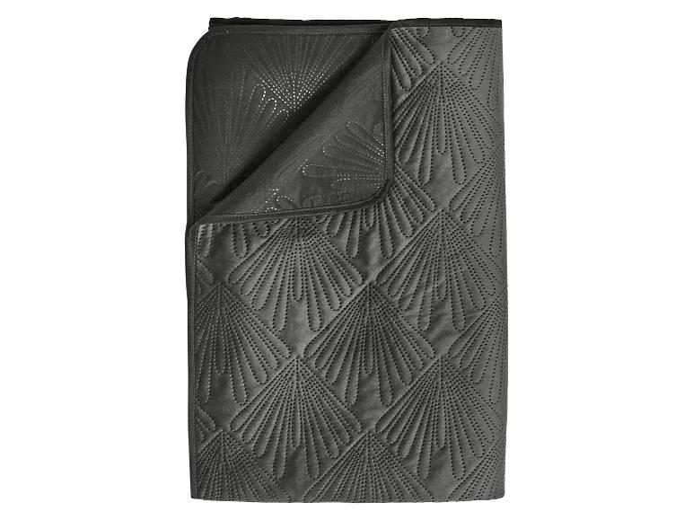 Donkergrijze deken met een gewatteerd waaierpatroon.