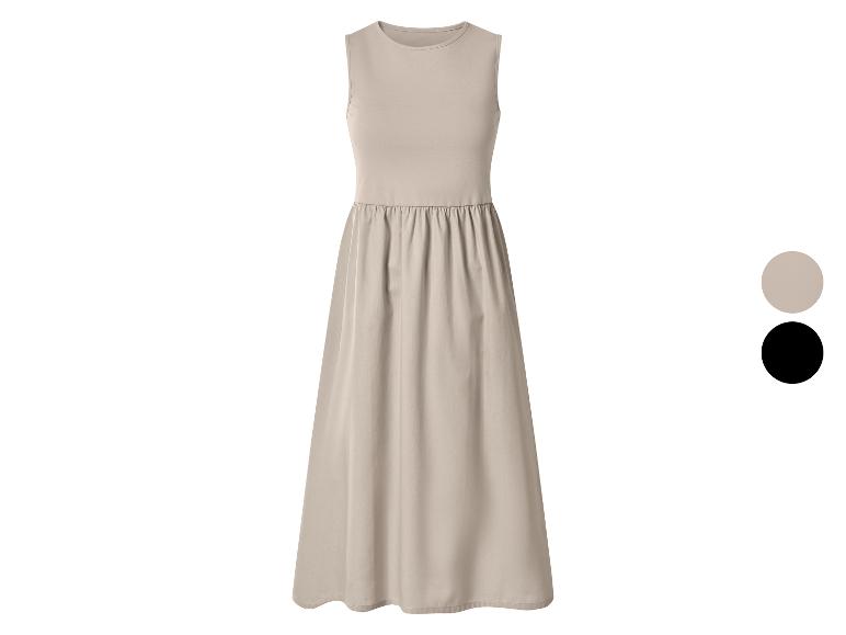 Beige mouwloze damesjurk met geplooide rok, ook verkrijgbaar in zwart.