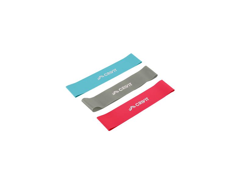 Drie Crivit fitness elastieken in blauw, grijs en roze.