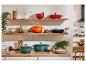 Stijlvolle keuken met Le Creuset gietijzeren potten in groen, oranje en rood.