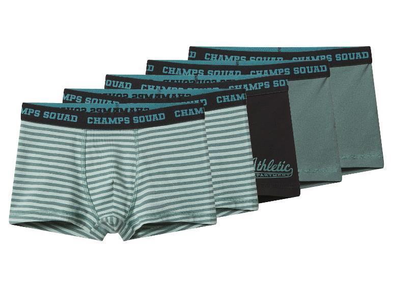 Vijf herenboxershorts in groen, zwart en gestreepte patronen, met 'CHAMPS SQUAD' taillebanden.