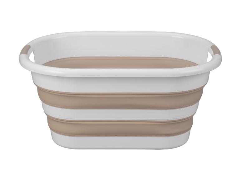 Opvouwbare wasmand in wit en beige.