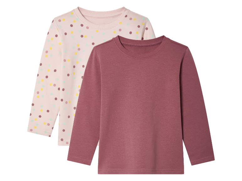 Twee longsleeve shirts voor meisjes: een roze met stippen en een effen roze.