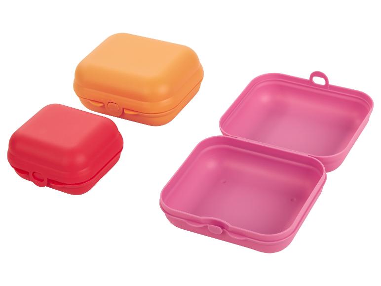 Lunchboxen in oranje, roze en rood; perfect voor broodjes.