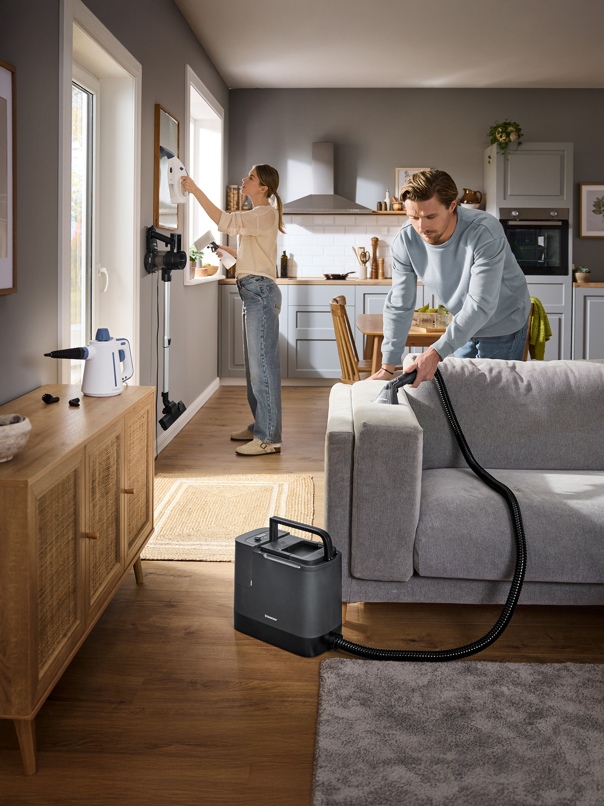 Paar maakt huis schoon met SilverCrest raamreiniger en textielreiniger.