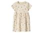 Beige kinderjurk met korte mouwen en zwarte hartjes.