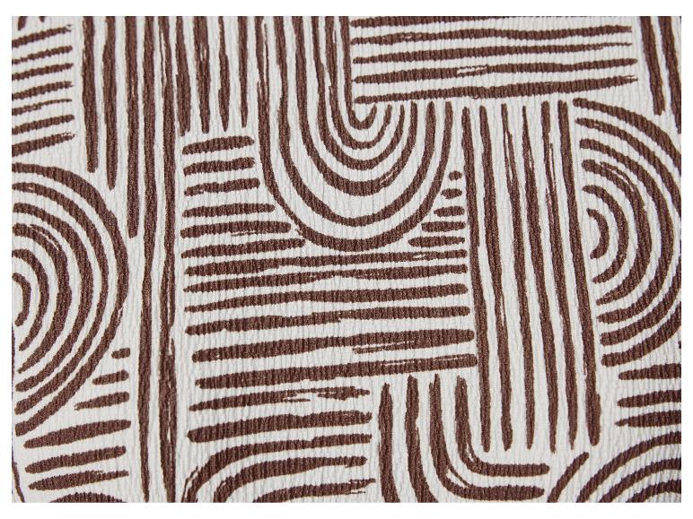 Stof met bruin-wit geometrisch patroon.