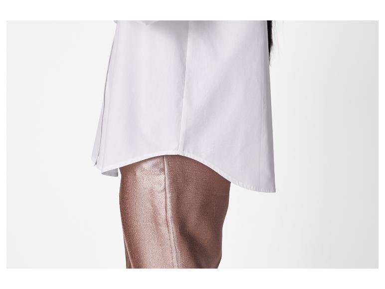 Een wit overhemd en een bronzen broek.