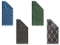 Vier LOOKS handdoeken in verschillende kleuren en patronen.