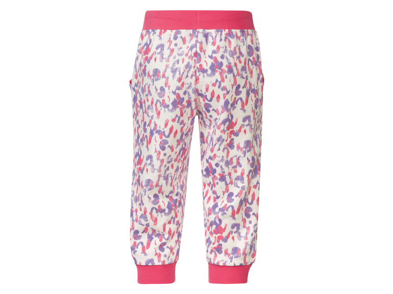 Kinderbroek met roze en paarse stippenprint.