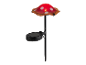 Solar lamp in de vorm van een rode paddenstoel met witte stippen.