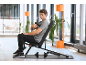 Man gebruikt een massagepistool zittend op een fitnessbank in een moderne sportschool.