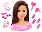 Poppenhoofd met bruin haar, make-uppalette, haarclips, krulspelden en stickers.